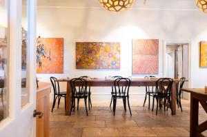 a dining room with a large wooden table and chairs at Prairie Hotel in Flinders Ranges