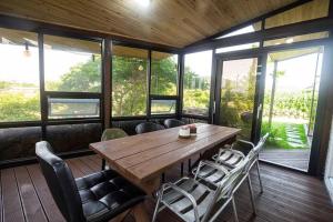a dining room with a wooden table and chairs at Arche House B in Jeju