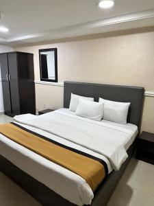 A bed or beds in a room at Msquare Hotel GRA