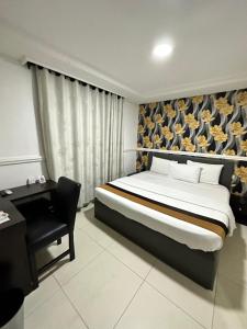 A bed or beds in a room at Msquare Hotel GRA