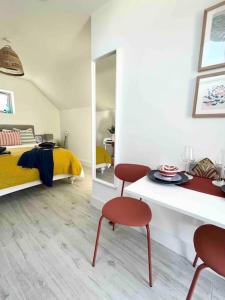 a bedroom with a bed and a table and chairs at The Loft Curracloe, on Wexfords Coastal Scenic Route in Wexford