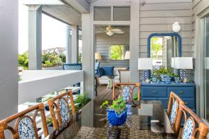 a porch with chairs and a table on a house at 2465 Racquet Club Villa in Seabrook Island