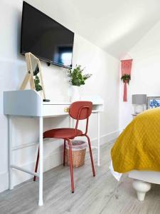 a bedroom with a desk with a television on top of it at The Loft Curracloe, on Wexfords Coastal Scenic Route in Wexford