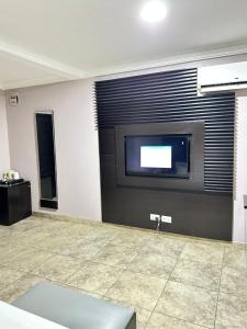 A television and/or entertainment centre at Msquare Hotel GRA