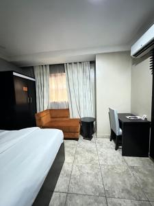 A bed or beds in a room at Msquare Hotel GRA