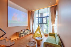 a living room with a couch and a big window at YAN YU JIAN Art Hotel in Zhangjiajie