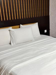 A bed or beds in a room at Msquare Hotel GRA