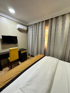 A bed or beds in a room at Msquare Hotel GRA