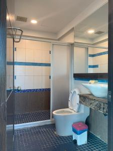 a bathroom with a toilet and a sink at Happiness Inn in Kenting