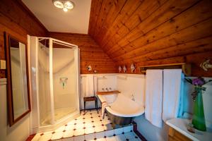 a bathroom with a shower and a sink and a tub at Poet's Cottage Stanley in Stanley +48 photos