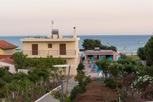 a house with a view of the ocean at Amaryllis front beach hotel in Lardos