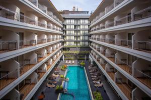 an apartment building with a swimming pool in the middle at Sabai Sabana in Pattaya