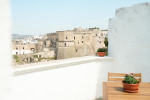 a balcony with two benches and a view of a city at Casa San Cosimo in Massafra