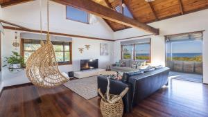 a living room with a couch and a hammock at The Point Ultimate Beach House in Yamba