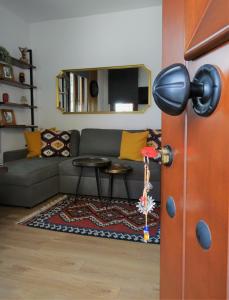 a living room with a couch and a table at Κάλλος-Kallos Apartment in Metsovo