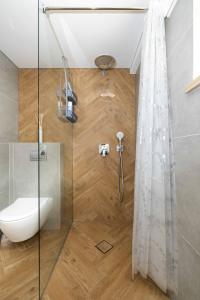 a bathroom with a shower with a toilet and a shower curtain at New Apt w/Terrace, By Cohost in Palanga