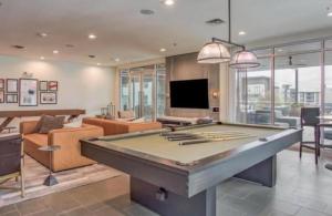 a large living room with a pool table at 2Brd Luxury Suite with Pool in Fort Worth Texas in Fort Worth