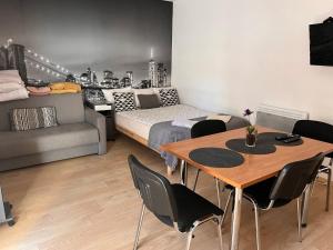 a living room with a table and a couch at White Garden in Oświęcim