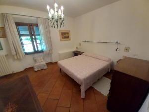 a bedroom with a bed and a chandelier at Casa Lalla in Livorno