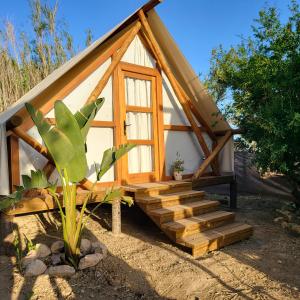 a small house with a staircase in front of it at Boho Glamping in Cádiz