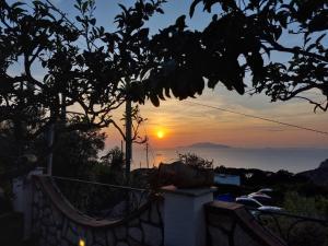 a sunset over the ocean from a house at Casa Astra in Anacapri