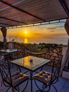 a table and chairs on a patio with a view of the ocean at Casa Astra in Anacapri