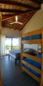 a bedroom with two bunk beds and a ceiling at Marcilia Beach Bungalows in Los Órganos