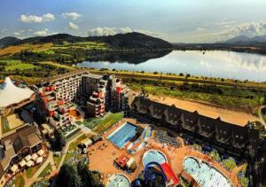an aerial view of a resort with a lake at Hotel Akvamarín in Bešeňová