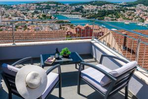 una mesa y sillas en un balcón con vistas en Apartment Ivan en Dubrovnik