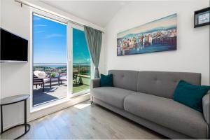 a living room with a couch and a large window at Apartment Ivan in Dubrovnik