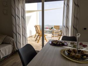 a dining room table with a plate of food on it at Athena Agrigento Apartments in Agrigento