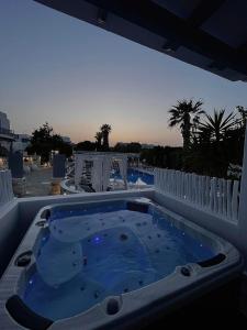 a hot tub on a patio with a view of the ocean at Zoumis Residence in Naousa