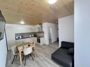 a living room with a table and a couch at GrenzApartments in Bietingen