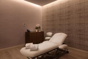a salon with a white chair in a room at Áurea Casa Palacio Sagasta by Eurostars Hotel Company in Cádiz