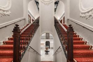 an image of a staircase in a building with red carpeted stairs at Áurea Casa Palacio Sagasta by Eurostars Hotel Company in Cádiz