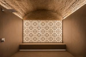 a window in a room with a patterned wall at Áurea Casa Palacio Sagasta by Eurostars Hotel Company in Cádiz