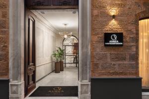 a hallway with a sign on a brick wall at Áurea Casa Palacio Sagasta by Eurostars Hotel Company in Cádiz