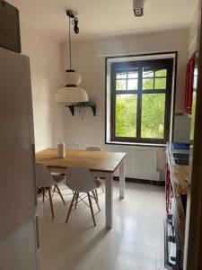 a kitchen with a table and chairs and a window at Apartment Garbo in Stockholm