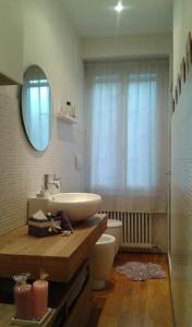a bathroom with a sink and a toilet and a mirror at B&B Il Ballatoio in Milan