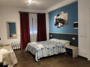 a hotel room with a bed and red curtains at Belvedere Rooms Guest House in Rome