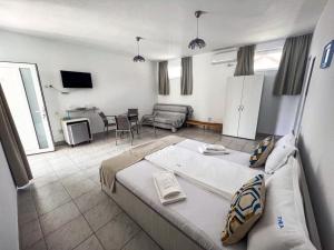 a living room with a large bed and a couch at Vila Ithea in 2 Mai