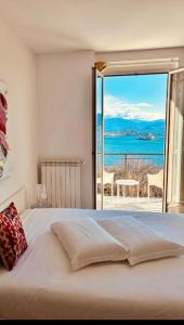 a bedroom with a bed with a view of the ocean at Suite in Baveno