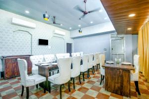 a conference room with white chairs and a wooden table at FabHotel Golden Temple Paradise - 50 meters from Golden Temple in Amritsar