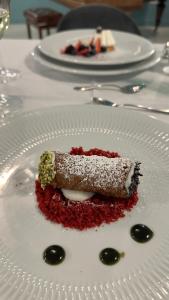 a piece of food on a white plate on a table at Experience Boutique Hotel - Villa Cimmino in Castellammare di Stabia