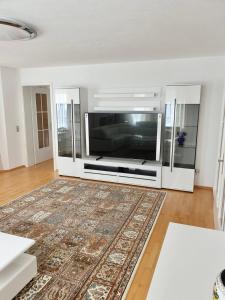 a living room with a large flat screen tv at Blackforest FeWo in Freudenstadt