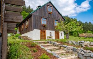 a wooden house with a stone path leading up to it at Amazing Home In Donji Babin Potok With Jacuzzi in Donji Babin Potok