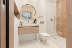 a bathroom with a toilet and a sink and a mirror at Cozy & Sunny Studio for 4 Guests Kolejowa Warsaw by Renters in Warsaw