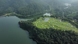 an island in a lake with a herd of animals at Beijing Marriott Hotel Yanqing in Yanqing