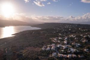 an aerial view of a town next to a body of water at Jarko Luxury Houses in Argoulidhés