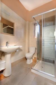 a bathroom with a toilet and a sink and a shower at El Greco Studios in Agia Marina Nea Kydonias +46 photos
